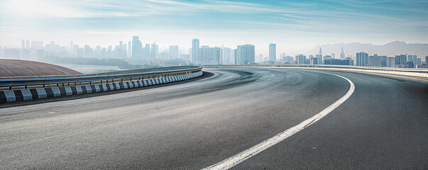 Curved asphalt road leading to a modern city skyline. Urban landscape background with copy space
