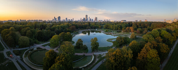 Pole Mokotowskie park in autumn with Warsaw city skyline, high resolution panorama at sunset.