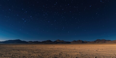 A breathtaking night sky over a serene desert landscape, showcasing vibrant stars and majestic mountain silhouettes.