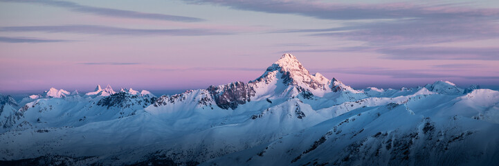 Panoramic view of Queyras mountain range at sunrise; mountains covered by snow 