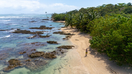 Drone Aerial view at sunrise of some beautiful hidden beach with cristal clear water in the island Isla Colon, Bocas de Toro, Panama