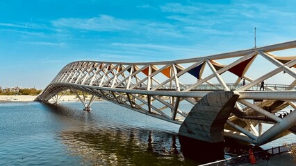 Experience the Atal Pedestrian Bridge at Sabarmati Riverfront, Ahmedabad, with this stunning landscape photo. Showcasing architectural brilliance against serene river views.