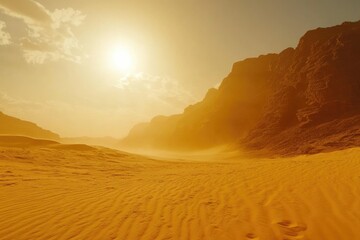 Golden desert landscape at sunset, with sunlit sand dunes and hazy mountains in the background.