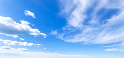 Cloud Shadows in the Sky. In the deep blue sky, clouds of various shapes float lightly. Some are like fluffy cotton wool, and some are like flowing ribbons, showing the purity and beauty of the sky on