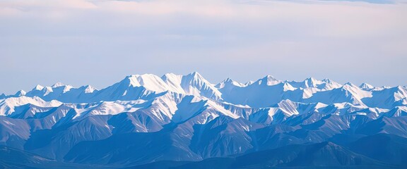 A snow-capped mountain range stretches to the horizon under a vast, clear sky, range, alps