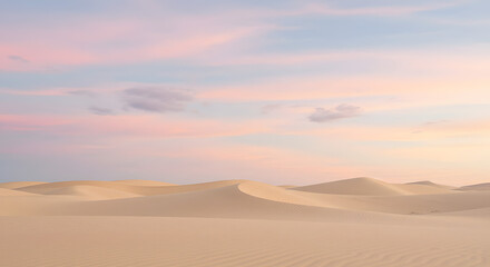 Serene desert landscape at sunset with soft sand dunes under colorful sky
