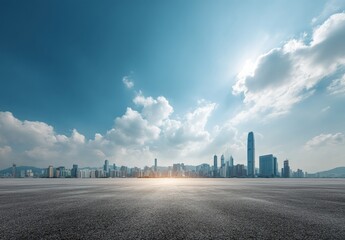 Empty asphalt road with sunlight reflection and Hong Kong skyline in background, offering a panoramic view of urban landscape and modern architecture