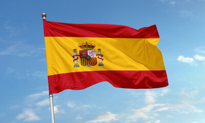 Spain national flag with royal coat of arms waving in the sky