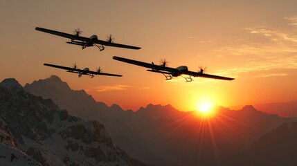 Silhouettes of three large drones soaring above snow-capped mountains at sunset.