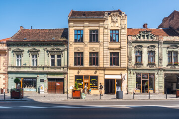 View of streets and historical buildings in old town Brasov, Romania. People and history of Romanian town in Transylvania. Editorial