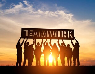 Silhouette of a team holding a sign that says Teamwork at sunset