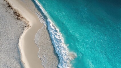 High-angle view of pristine beach meeting turquoise ocean waves