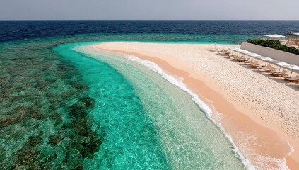 Sandy beach curves into turquoise water