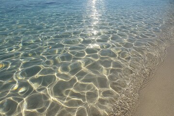 Crystal-clear shallow water, sunlit ripples
