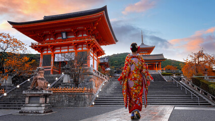 Japanese Woman in Traditional Kimono Dress at Kiyomizu-dera temple with beautiful foliage in autumn in Kyoto, Japan