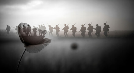 Double exposure of soldiers marching and a poppy. Black and white image of war and remembrance. Remembrance Day, Poppy Day, Veterans Day, Memorial Day