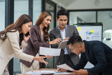 Asian business group meets to explain presentations and plan business and investment projects.