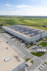 Logistics centers with solar panels on roofs. Aerial view