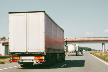 Cargo truck on clear blue sky highway.