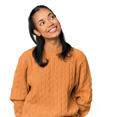 Young Filipina woman relaxed and happy laughing, neck stretched showing teeth.