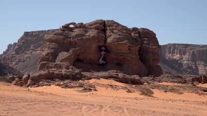 A trip to Sahara desert in Algeria. Beautiful african travel photo. Sandy landscapes, mountains, rocks, dunes, and nature. Summer vacation in arab country.
