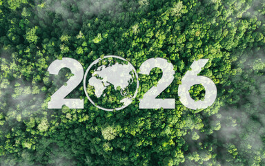 Aerial view of green forest with 2026 and Earth icon for environmental awareness, sustainability goals, and climate change action, happy new year and environment day, carbon reduction to net zero.