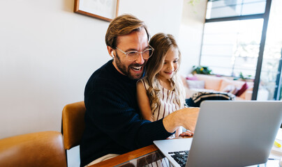 Father and daughter love learning on laptop at home