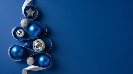 Mood of festive blue and silver decor featuring Christmas tree shape, ribbon and glitter on a deep blue backdrop, capturing Christmas vibe and New Year celebration and warm greeting for the season