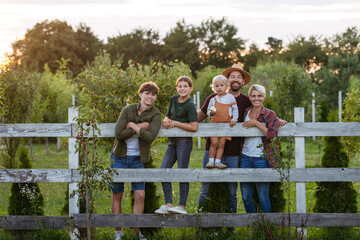 Farmer family portrait. Prents with three kids.