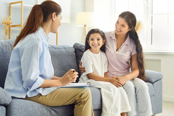 Family and counselor in therapy session support. A psychologist meets with mother and child girl in clinic office, offering guidance and consultation. Concept mental health and psychology support.