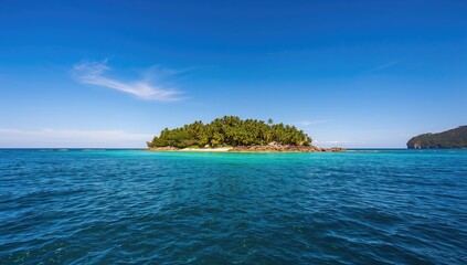 Tropical isle surrounded by vast ocean beneath a clear blue sky