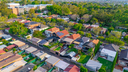 Aerial Panorama Drone View of a inner western Sydney Suburb of Ashbury Urban Sprawl and the terracotta roof tops streets and trees of Suburban Sydney NSW Australia