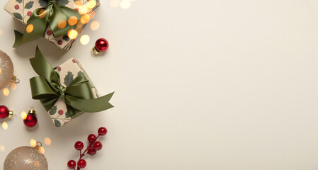 Merry Christmas and Happy Holidays greeting card, frame, banner. New Year. Christmas ornaments and gifts, presents on light beige background top view. Winter xmas holiday festive theme.