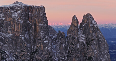 Panoramic view of Dolomite mountain peaks in beautiful morning light. Early winter scene with snow covered summits.