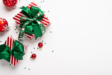 Merry Christmas and Happy Holidays greeting card, frame, border, banner. New Year. Red green Christmas decoration, ornaments and gifts, presents on white background. Xmas holiday festive theme.