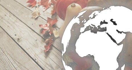 Overlaying globe graphic halftoning Europe Africa over wooden tabletop with pumpkins squash leaves