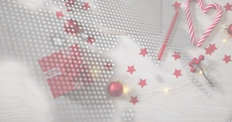 Showing red-gift-white-ribbon sitting left-center on wood-table, candy, baubles, lights, halftone