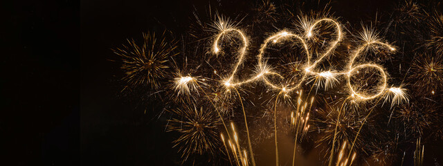 happy new year, new year's eve, silvester, new years eve, celebration greeting card, new year card - Year 2026 in sparkler font and firework fireworks pyrotechnic, isolated black night sky background