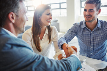 Business, people and meeting with handshake in office for real estate, agreement and auction deal. Smile, men and shaking hands for partnership, welcome client and thank you for property negotiation