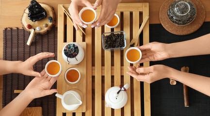 Women with Asian tea in cups, top view