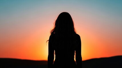 Silhouette of a woman with long hair standing against a vibrant orange and blue sunset sky, looking towards the horizon.