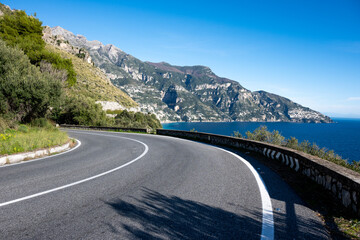 Positano and the Amalfi Coast seen from the road, with the characteristic coastal road in the foreground. Magical places in Italy