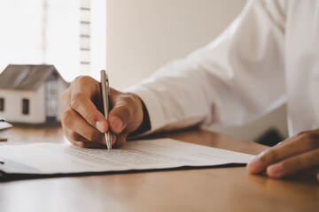 Hand of landlord, realtor pointing sign signature contract rental, purchase, buyer home or apartment with tenant, client after banker agreement mortgage, loan success or done. Property agent concept.