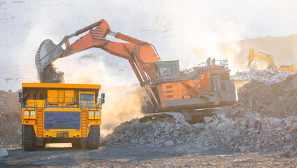 Heavy machinery in open coal mine during, sunlight