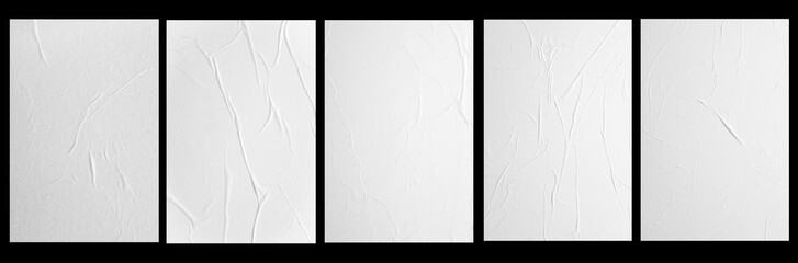 five white posters with folds isolated on a black background