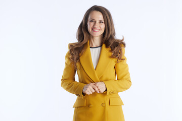 A friendly and confident businesswoman in a bright yellow blazer smiles directly at the camera with hands clasped, conveying approachability and professionalism.
