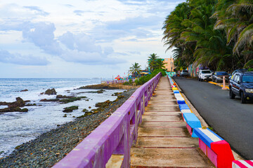 Colorful seaside promenade along the rocky coast of La Perla in San Juan, the capital city of Puerto Rico in the Caribbean