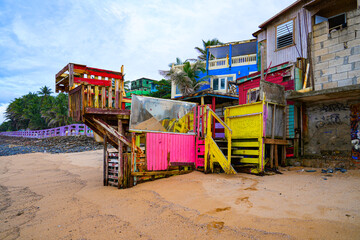 Dilapidated wooden structure on the beach of La Perla neighborhood in San Juan, the capital city of Puerto Rico in the Caribbean