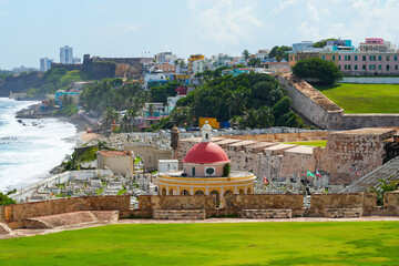 The iconic red-domed chapel of Santa Maria Magdalena de Pazzis Cemetery in fronf of La Perla neighborhood by the Atlantic Ocean in Old San Juan, Puerto Rico