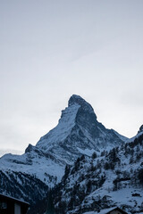 Matterhorn mountain peak rising above a snowy alpine landscape in winter, evoking skiing, mountaineering, adventure, and Swiss tourism.